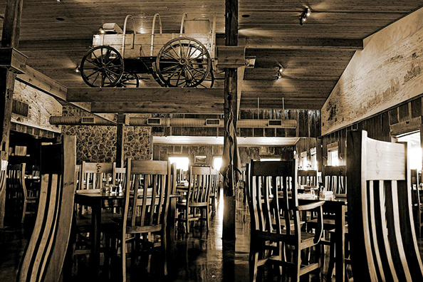 An 1890s chuck wagon is supspended from the ceiling at Cowcatcher Steaks. 