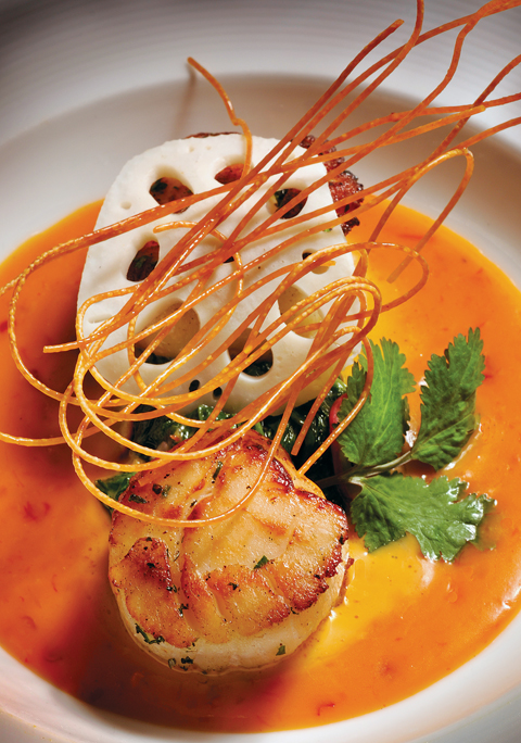 Crispy cappeline, lotus root and mint adorn seared scalloops with coconut-sake sauce. (Photo by Michael Amador)