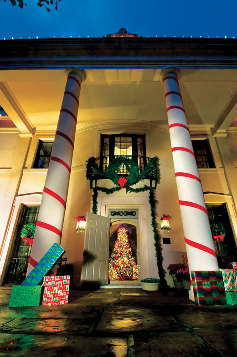 Festive with lights and ribbon-wrapped columns, Houston’s 14-acre Bayou Bend estate has become a popular holiday destination. (Photo by Kevin Stillman)
