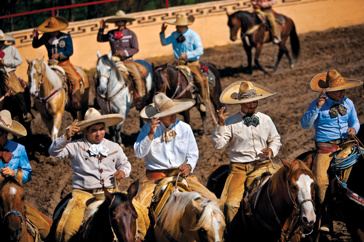 Teams of charros open the charreada by riding into the arena's circular rueda, each team forming its own line. (Photo by Julia Robinson)