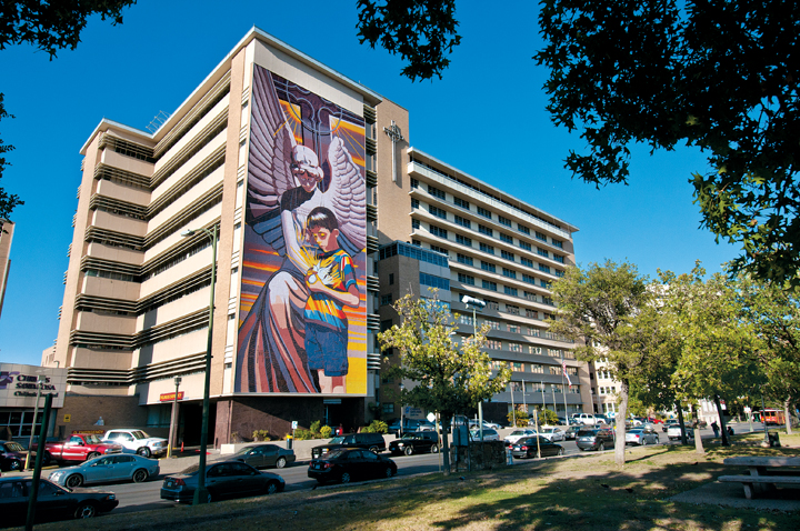 One of artist Jesse Treviño’s most visible pieces of public art, a nine-story mosaic mural titled Spirit of Healing, enlivens the side of Christus Santa Rosa Children’s Hospital. (Photo by Kevin Stillman) 
