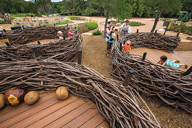 Human-scaled birds’ nests made from grapevines feature wooden “eggs.”