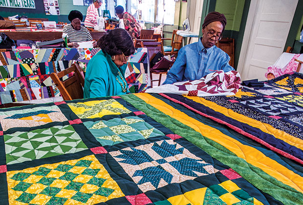 Alvis Dorsey and Flo Stevenson work on a quilt at the historic Pleasant Hill School.