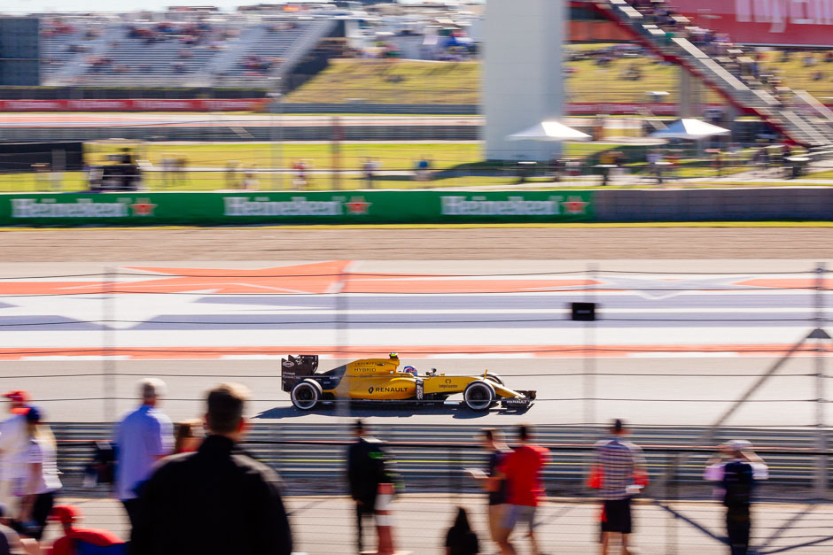 A Renault driver speeds past the general admission seating available at turn 16.