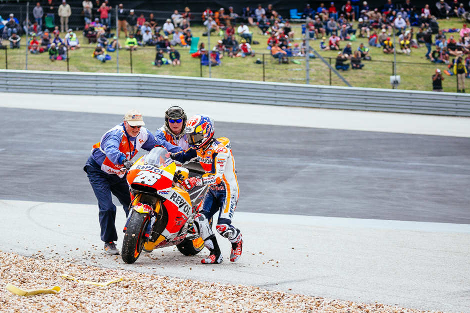 Cooler temperatures on Saturday meant maintaining grip with the tires proved difficult resulting in several minor crashes during qualifying. Here Dani Pedrosa gets back on his bike at turn one after a spill.