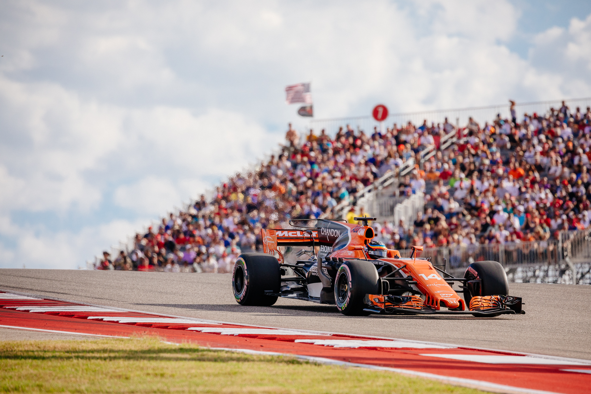 McLaren Honda's Fernando Alonso with the turn 1 grandstand in the background.