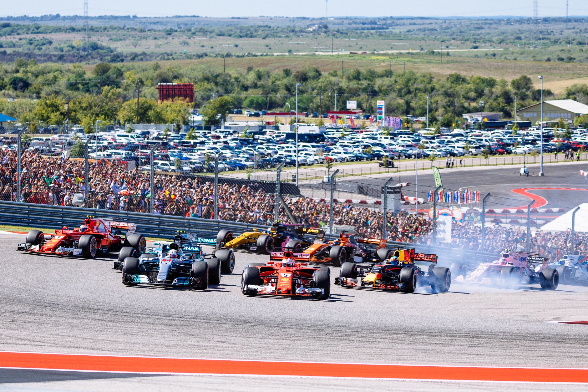 The field enters turn 1 at the start of the 2017 U.S. Grand Prix.