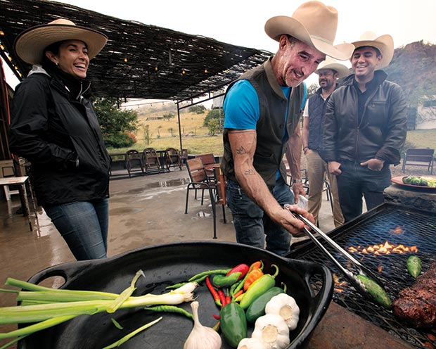 Lou lambert prepares grilled jalapenos and a beef tenderloin for friends at a family ranch North of Marfa.