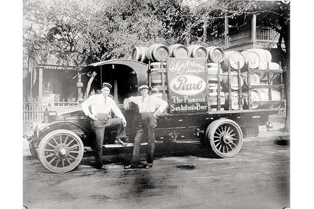 Historic photo of Pearl Brewery workers in front of delivery vehicle