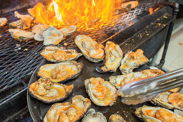 Oysters coming off a grill
