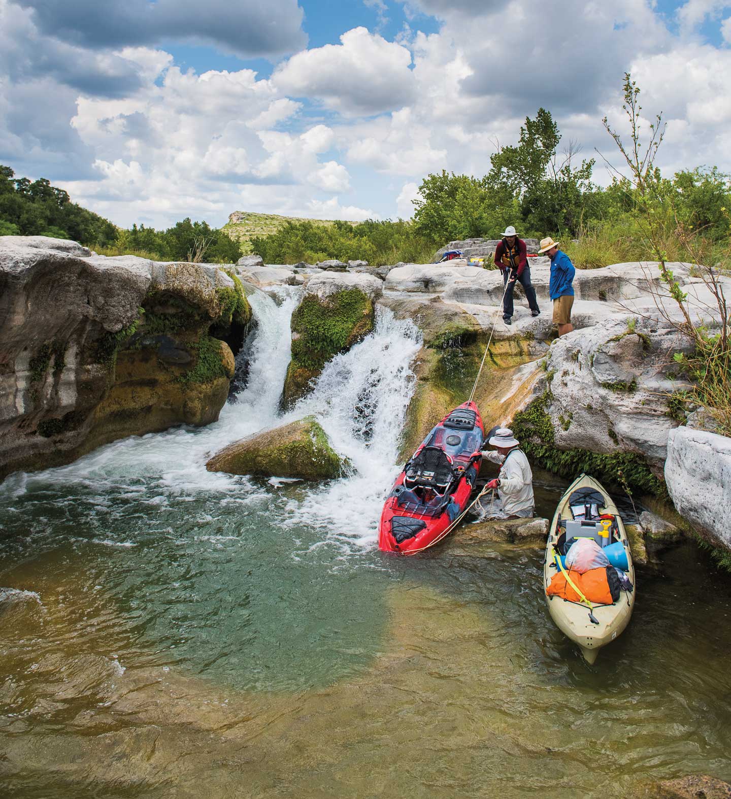 A kayak is carried over a waterfall.