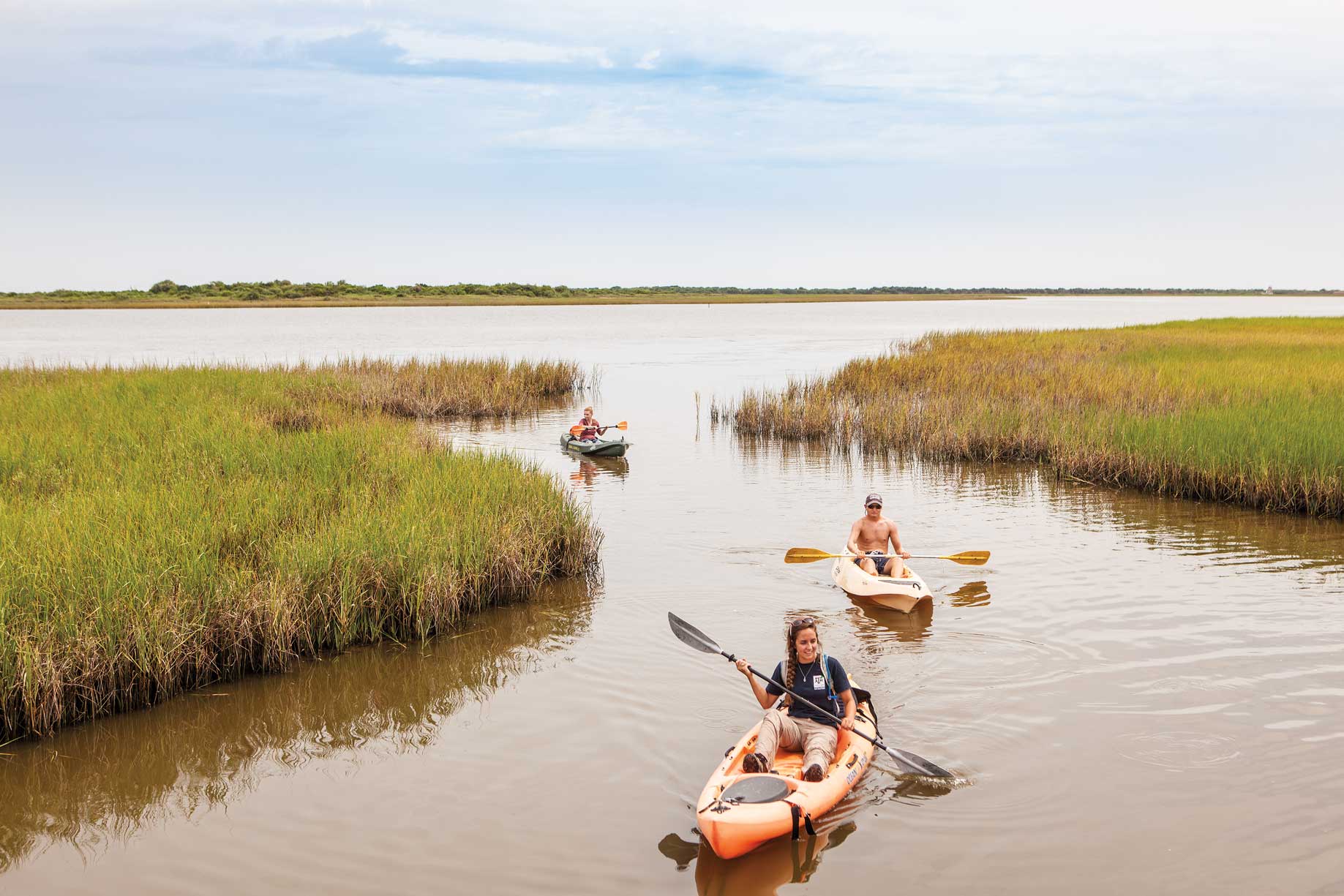Kayakers in a Gulf marsh