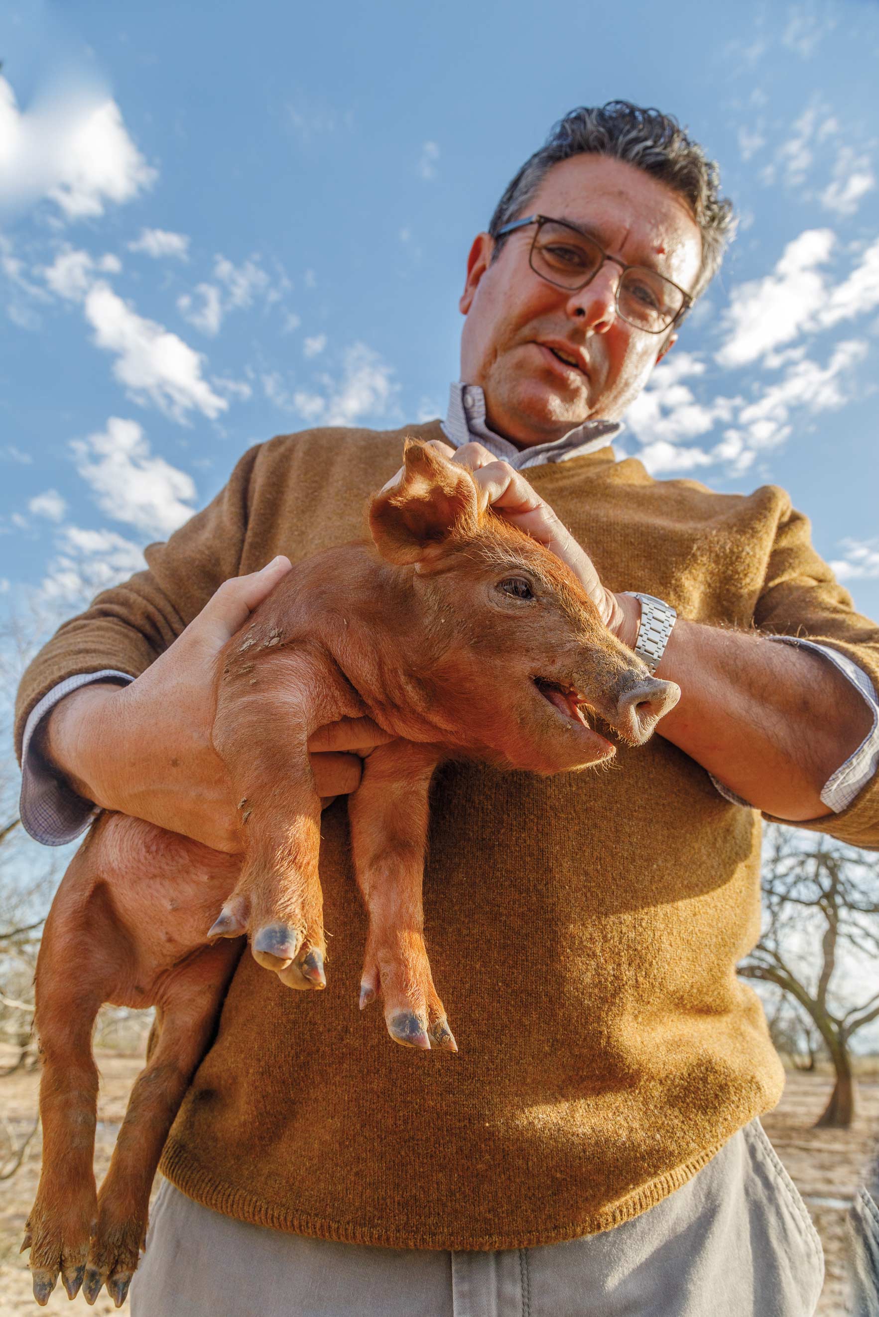 Manual Murga holding a piglet