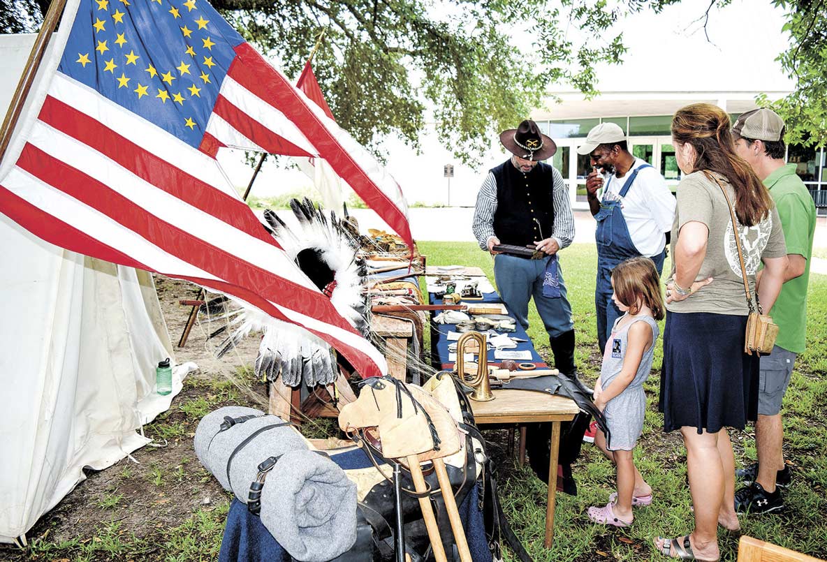 Visitors to Washington on the Brazos look an exhibit from the 1860s.