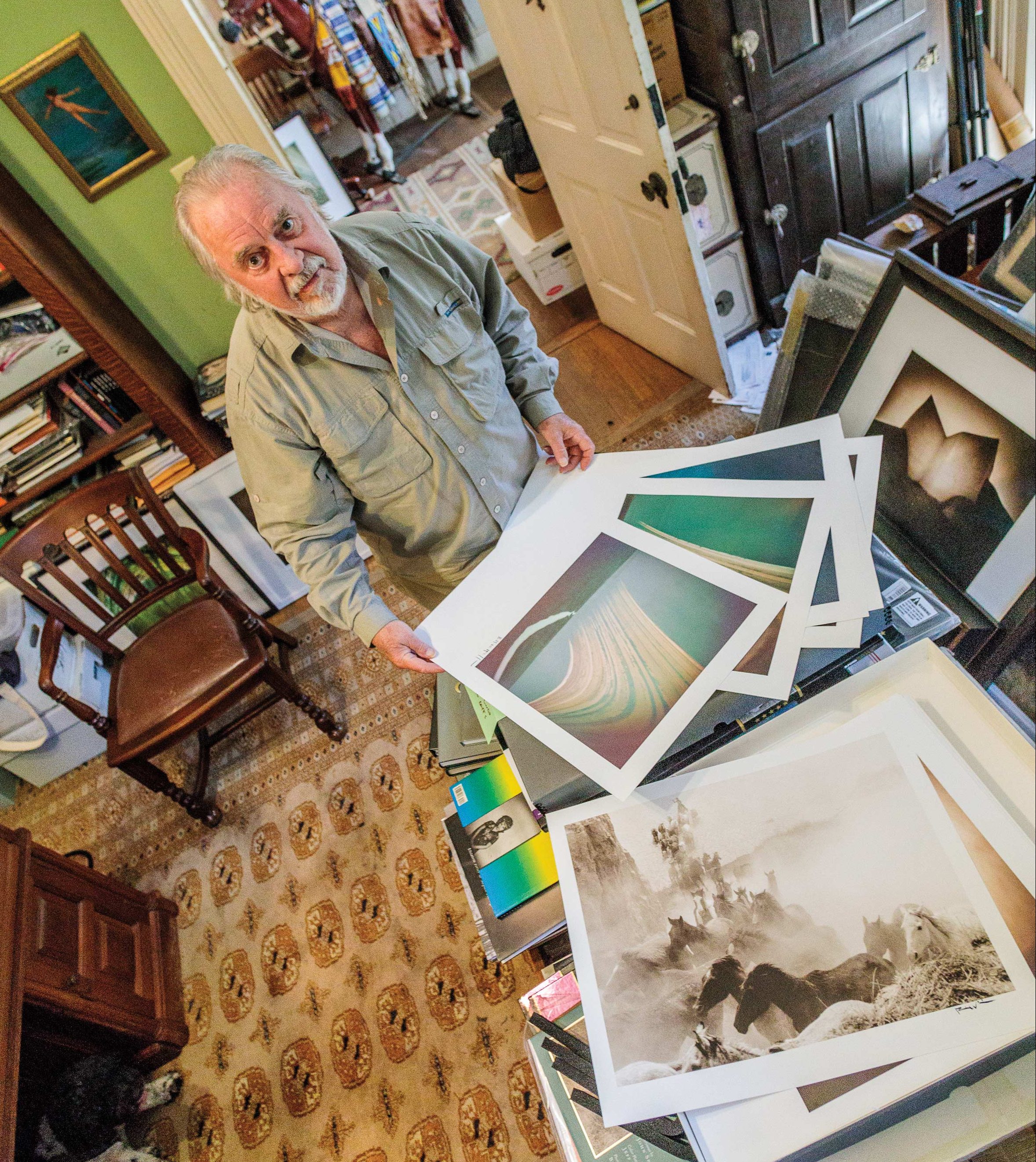 Bill Wittliff with prints of his solargraphs