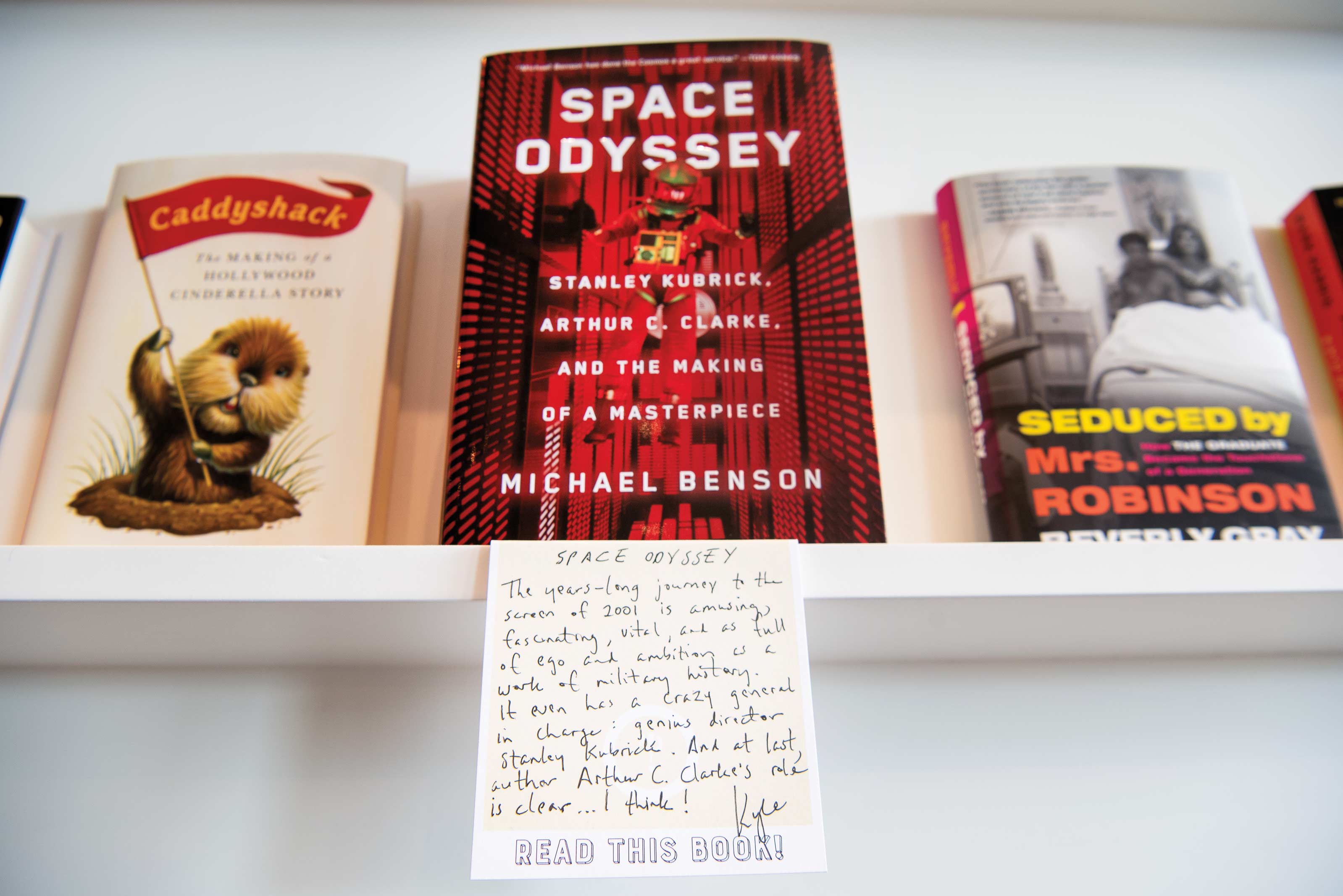 A handwritten note summarizing Space Odyssey on the shelf