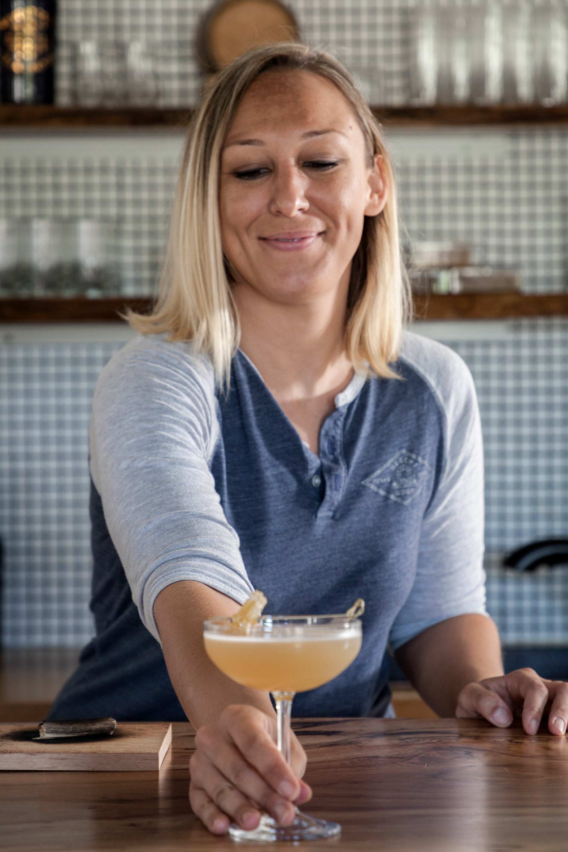 Bar manager Bobbi Lee Hitchon with a drink at the bar