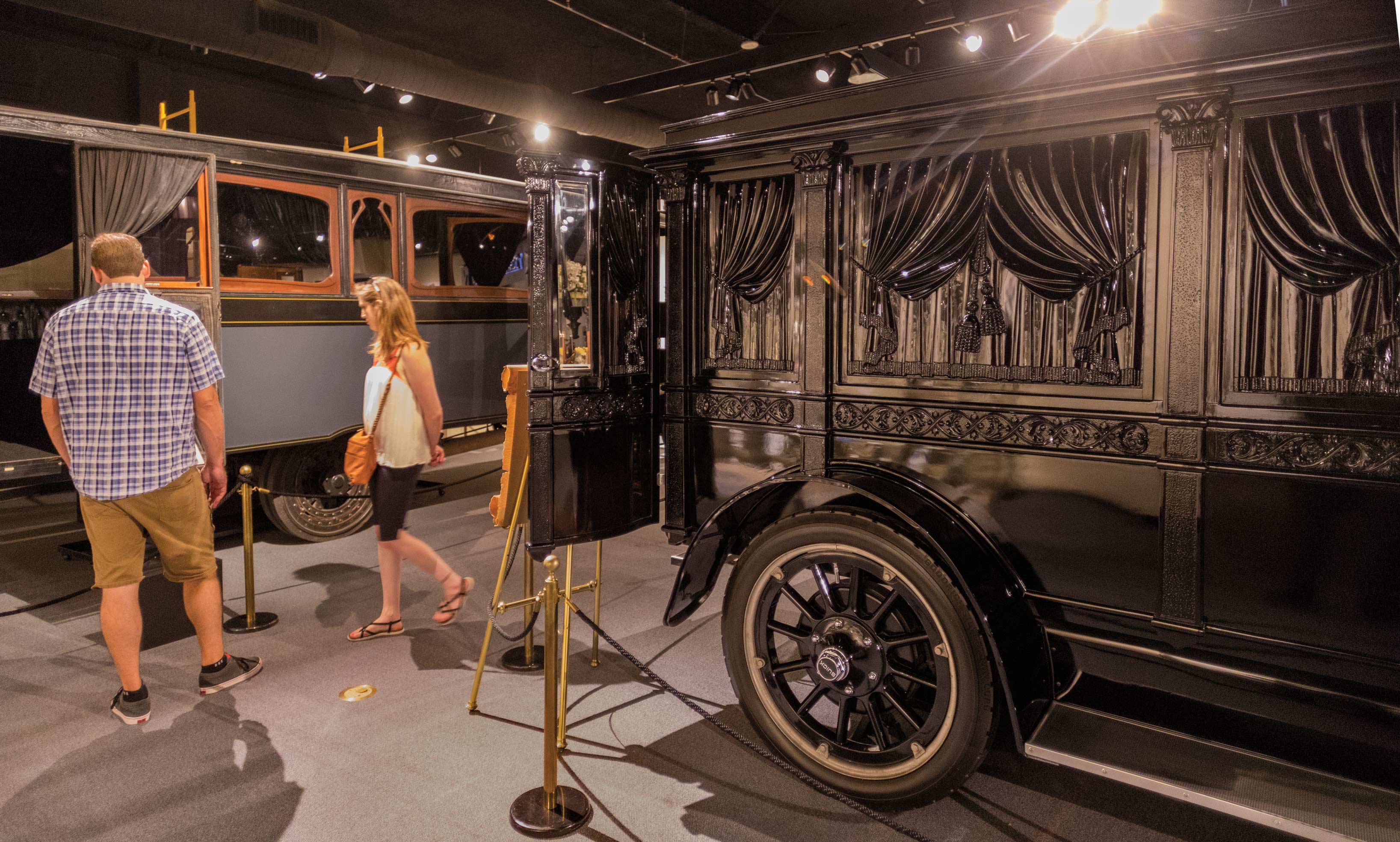 A couple looks at historical hearses