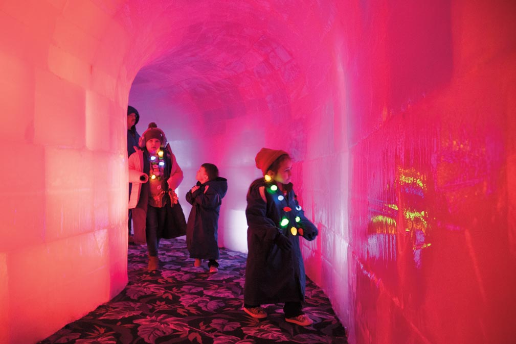 Children walk through an ice cave