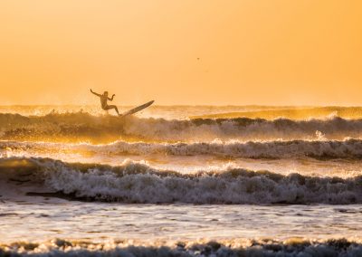 Serious Surfers Brave the Winter Chill to Ride Texas’ Waves