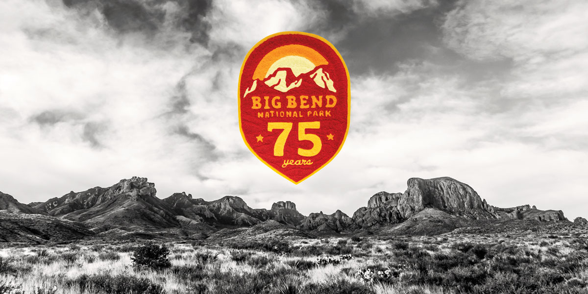 Black and white photo of the Chisos Mountains with commemorative Big Bend 75 years patch