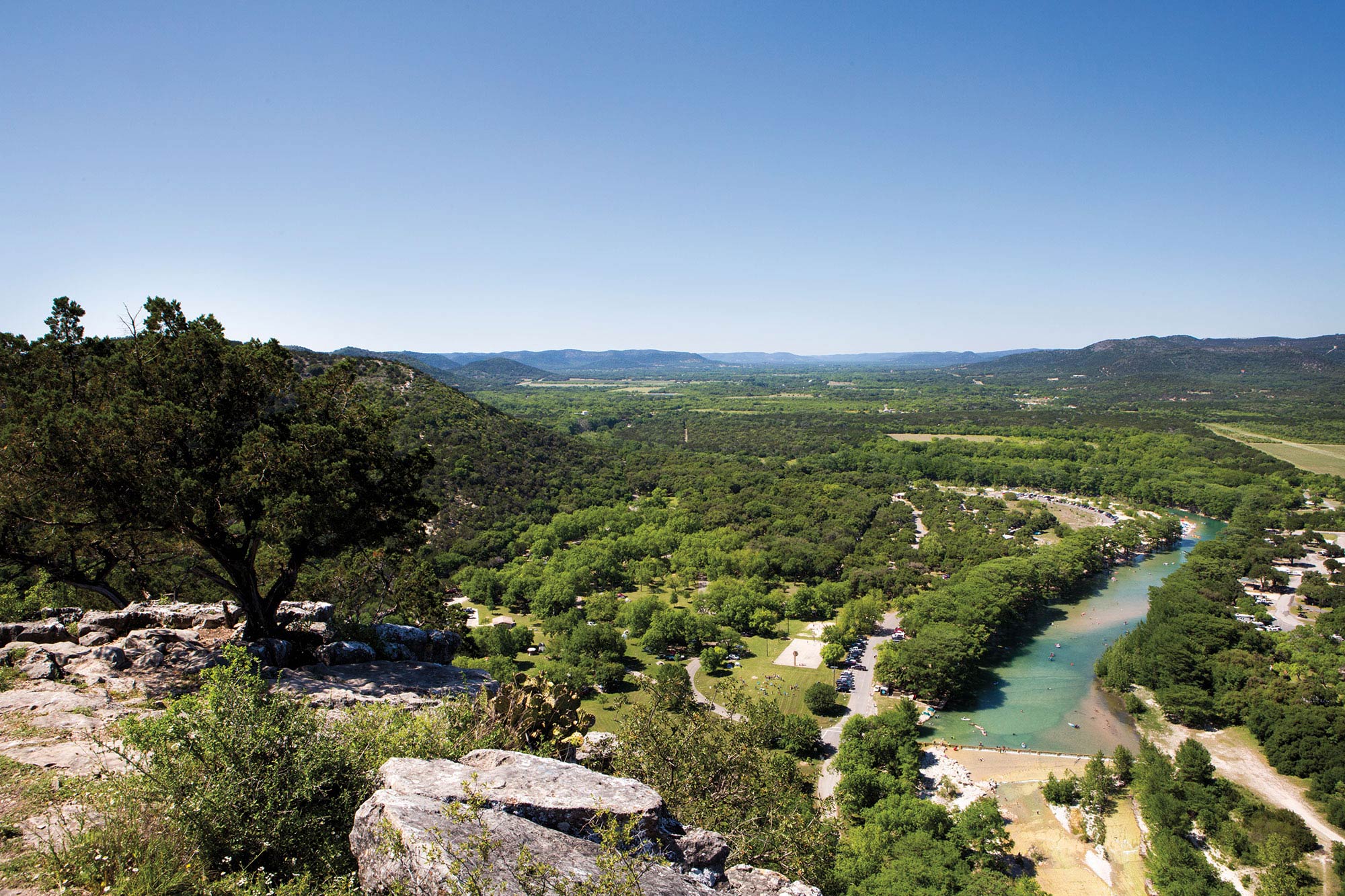 A view of the Frio River with blue sky and lots of trees