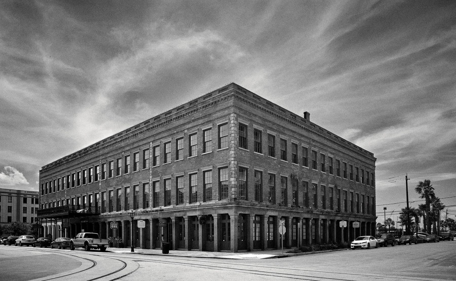 A black and white photograph of the exterior of a brick building