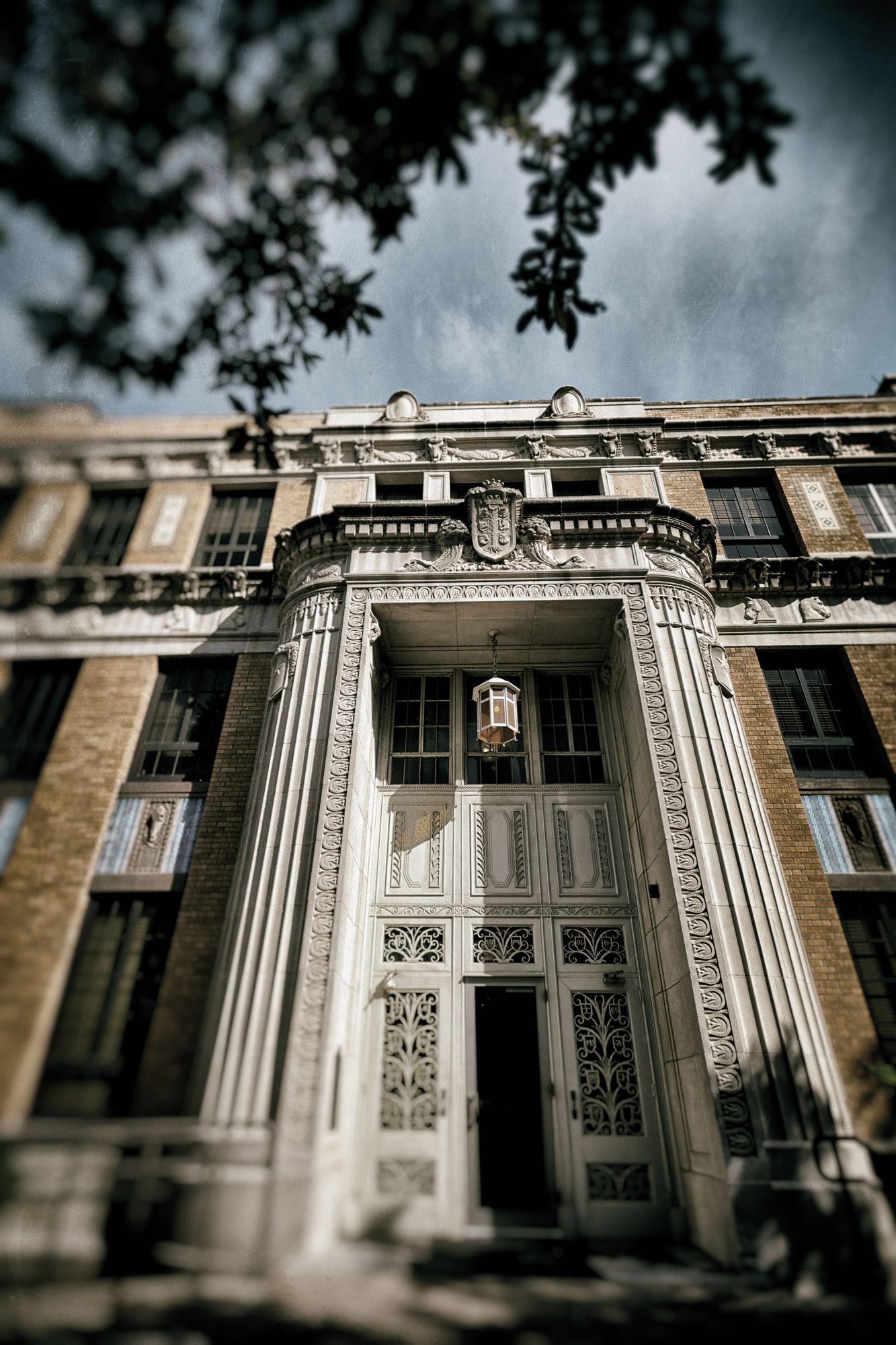 The exterior of a collegiate building with large gray pillars