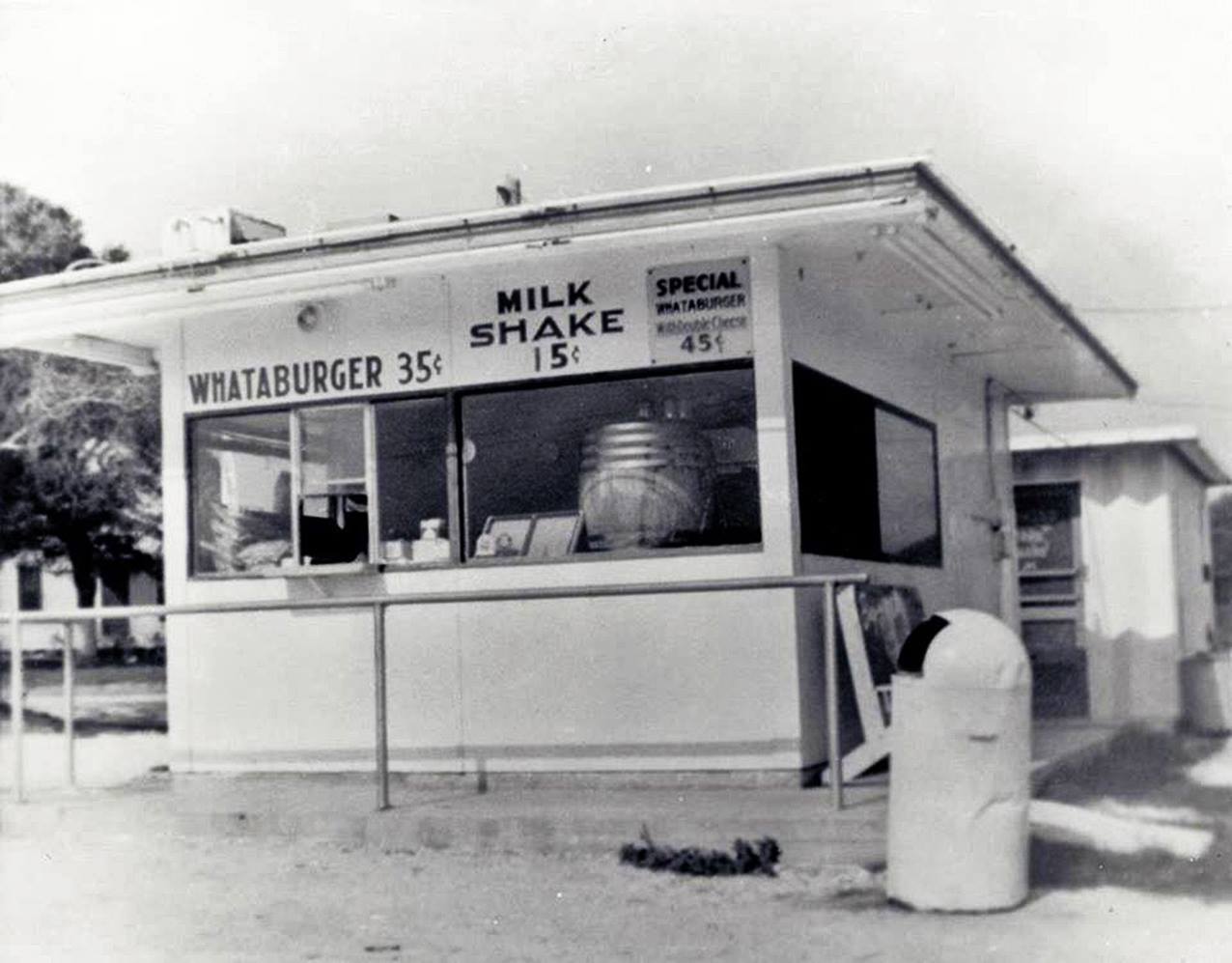 A black-and-white photo of an early Whataburger stand