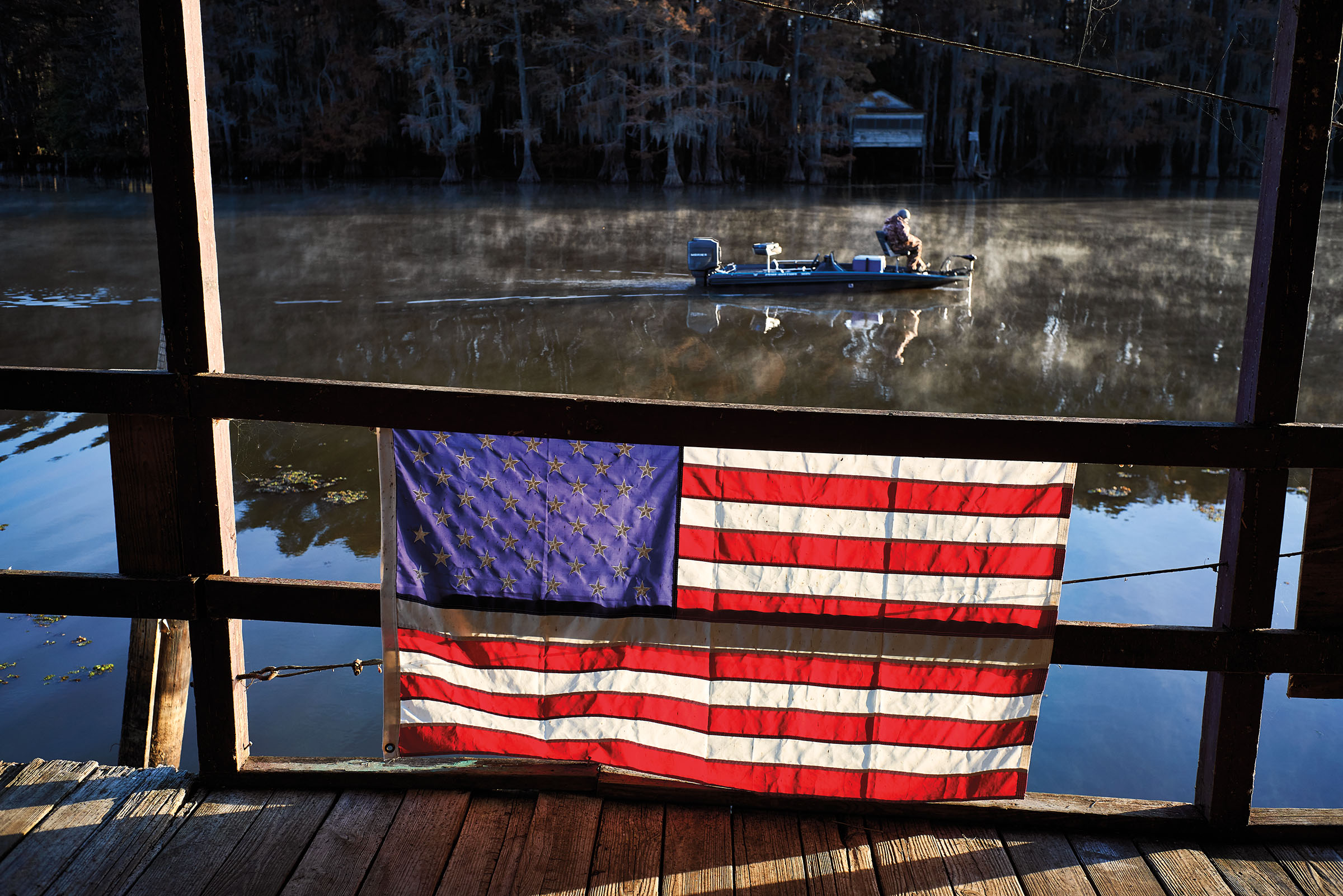 A man fishes on Caddo Lake during a cold November morning in Uncertain, Texas