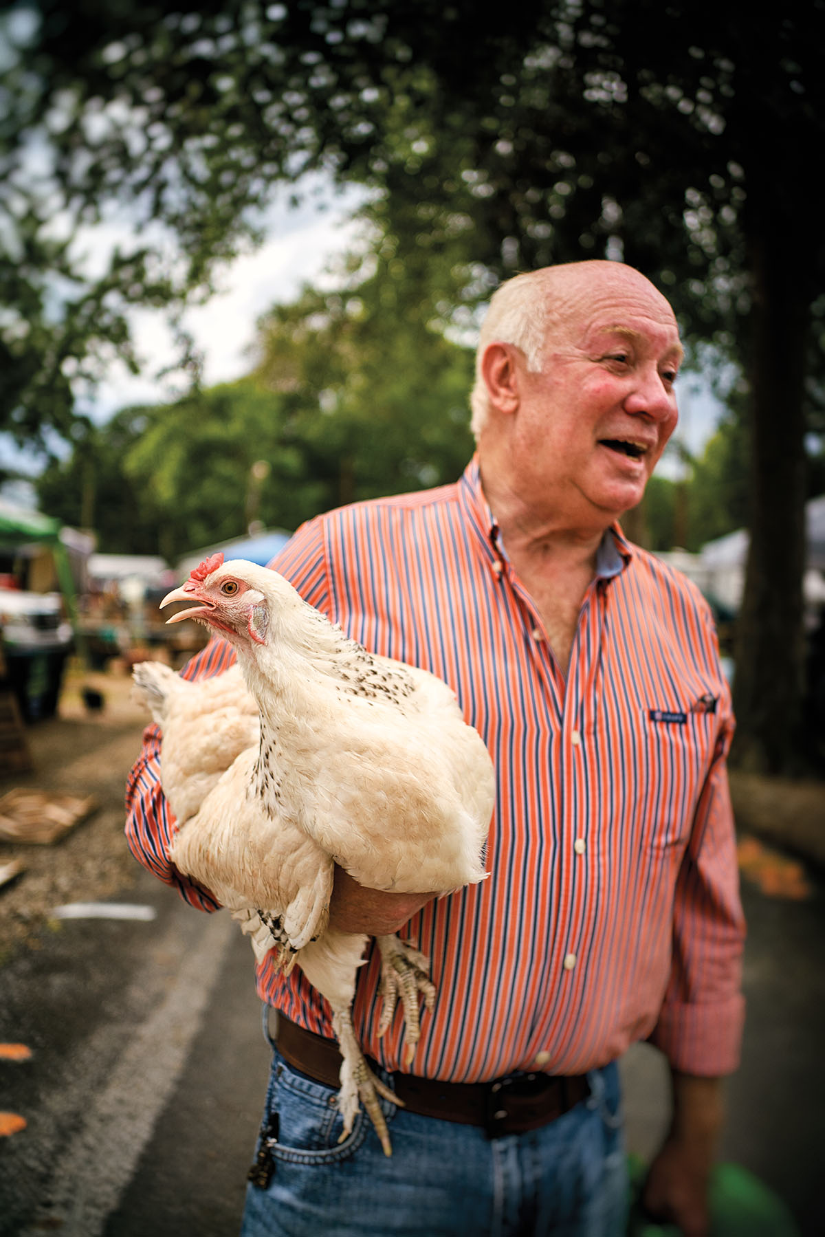 A man poses with his chicken during Trade Days in Canton Texas
