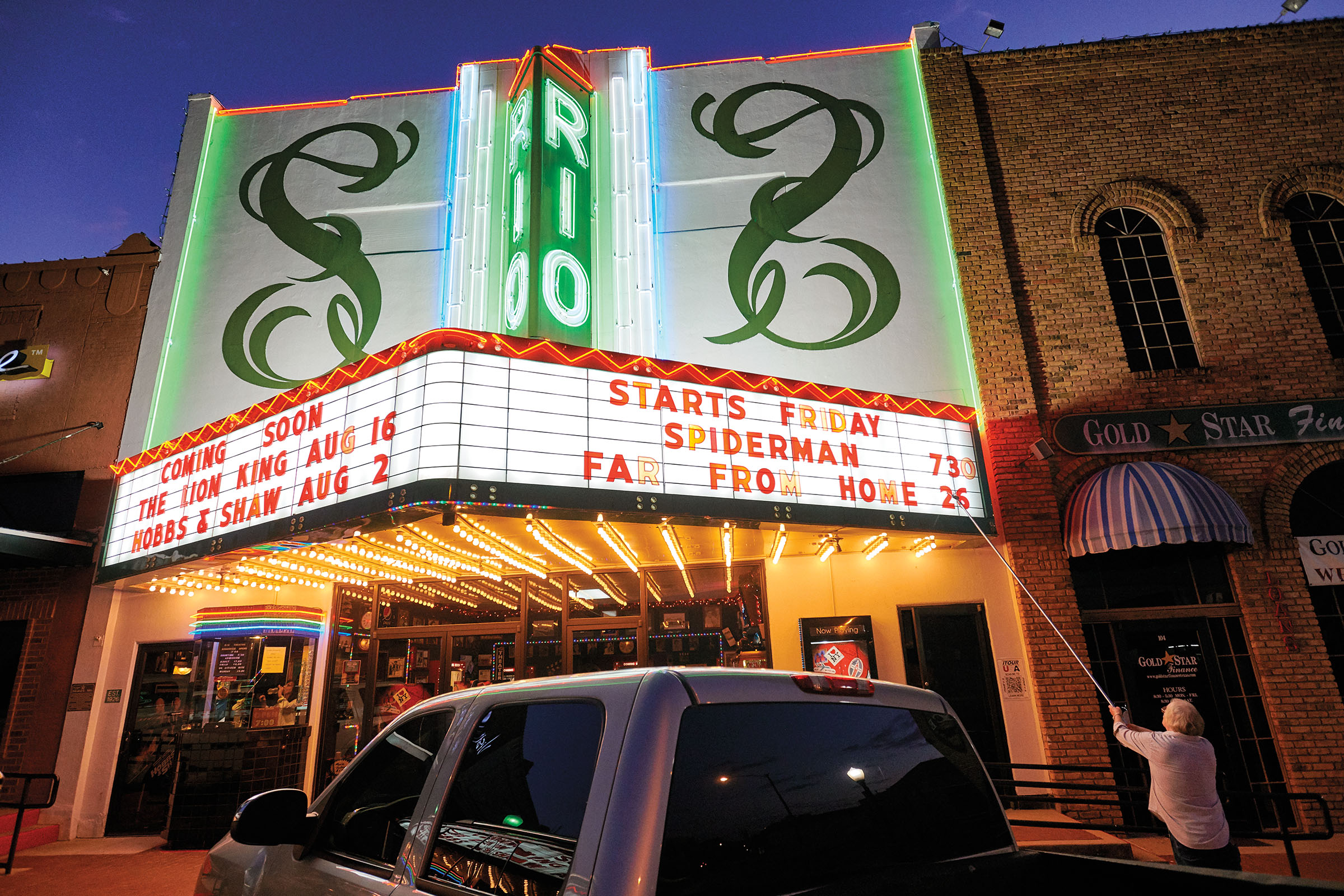 The owner of the Rio Theater in Center, Texas changes the message on the marquee.