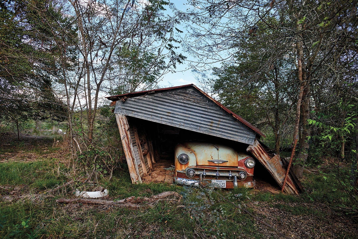 A Chevrolet parked in a run-down shelter in Como, Texas