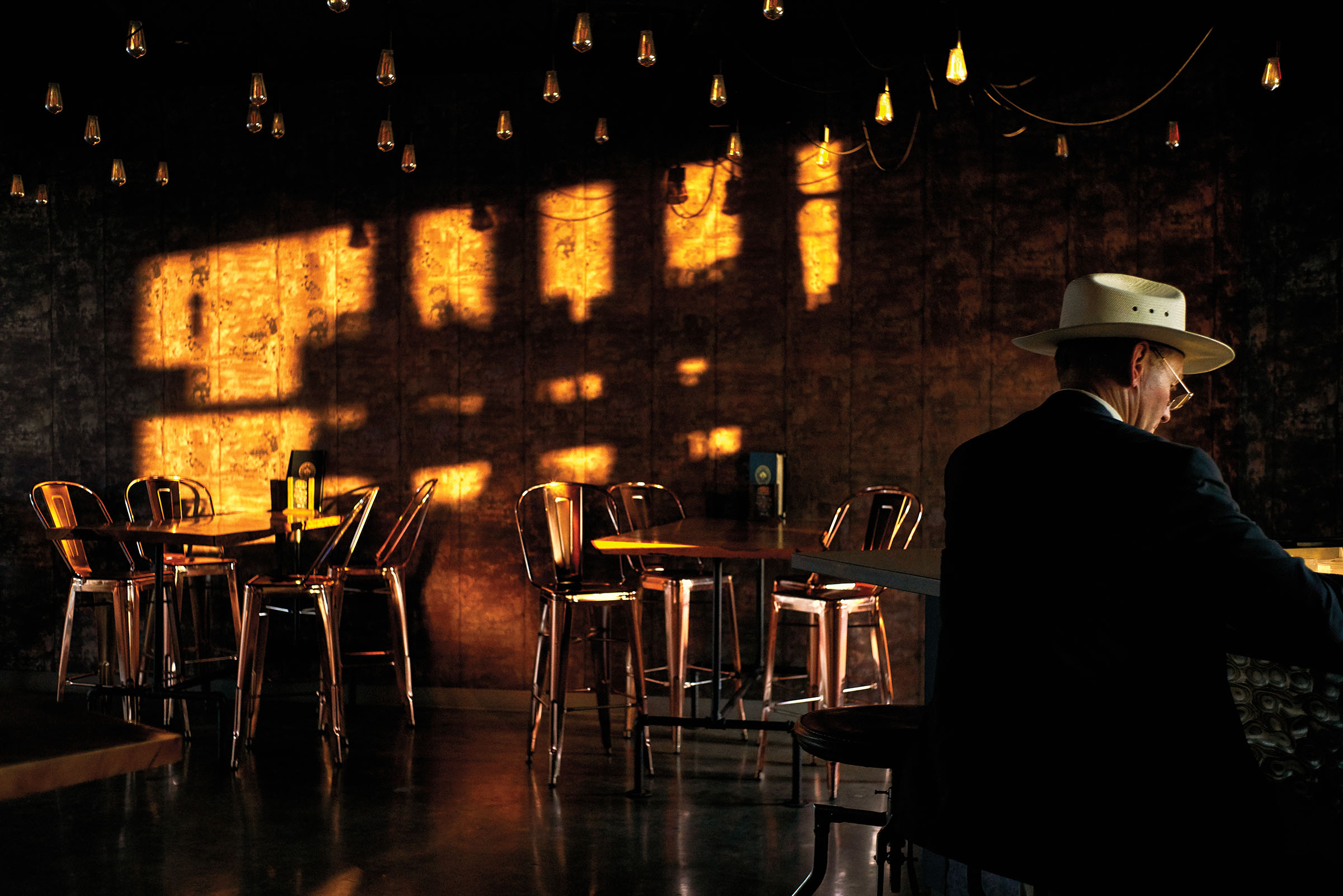 A man sits at Nine Flags Bar & Grill in Nacogdoches, TX