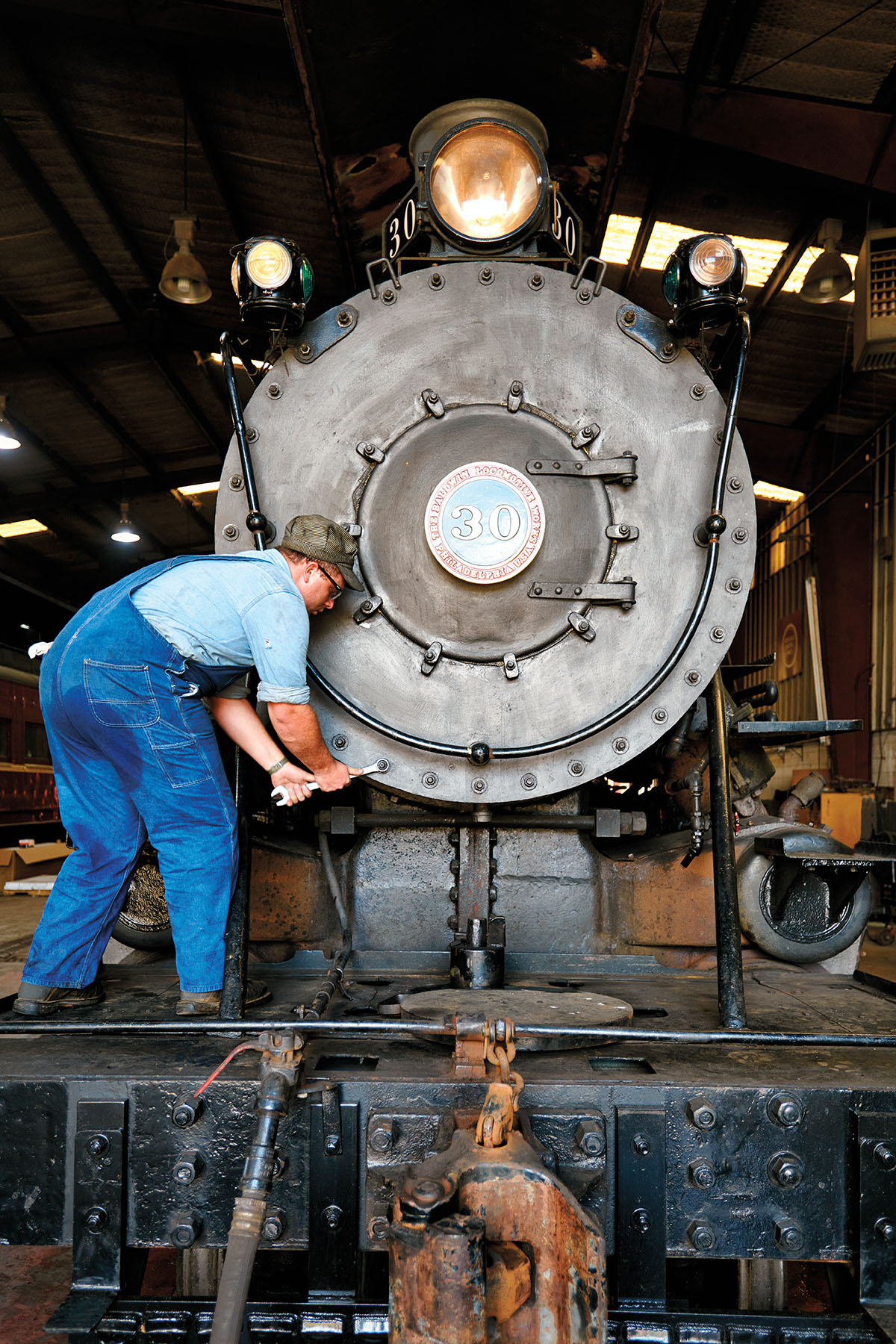 A man works on a locomotive of the Texas State Railroad in Palestine, TX