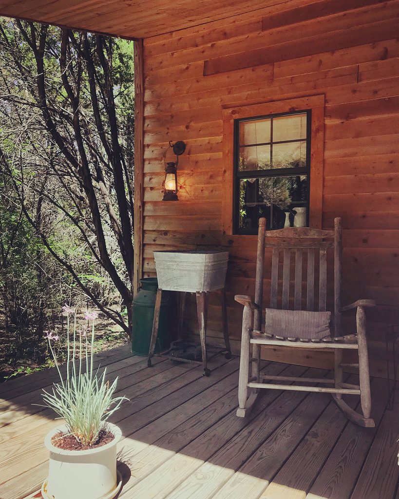 A rocking chair on the porch at Granbury Cabins