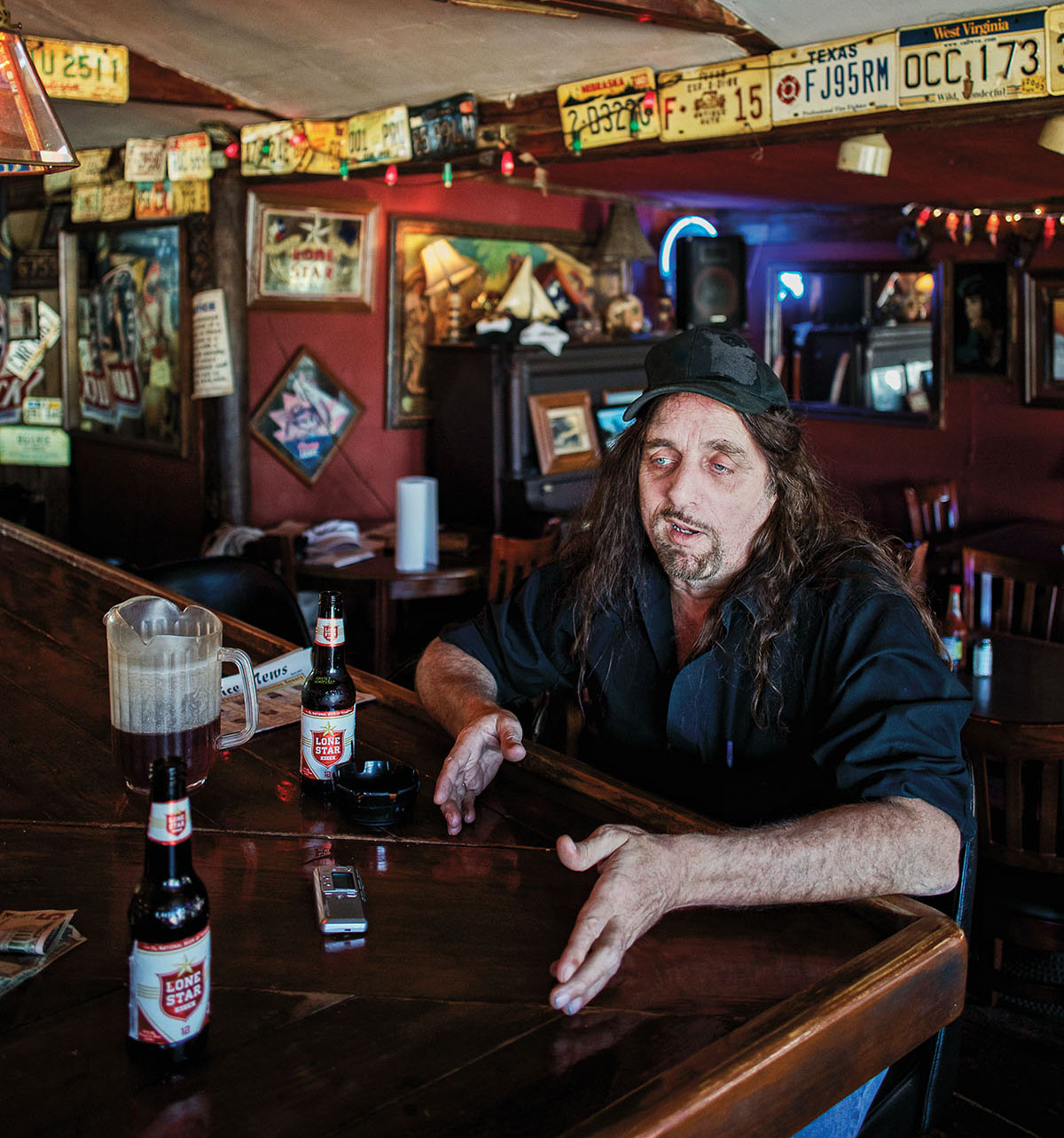 Gator Miller, publisher of the Seabreeze News, sits at a bar