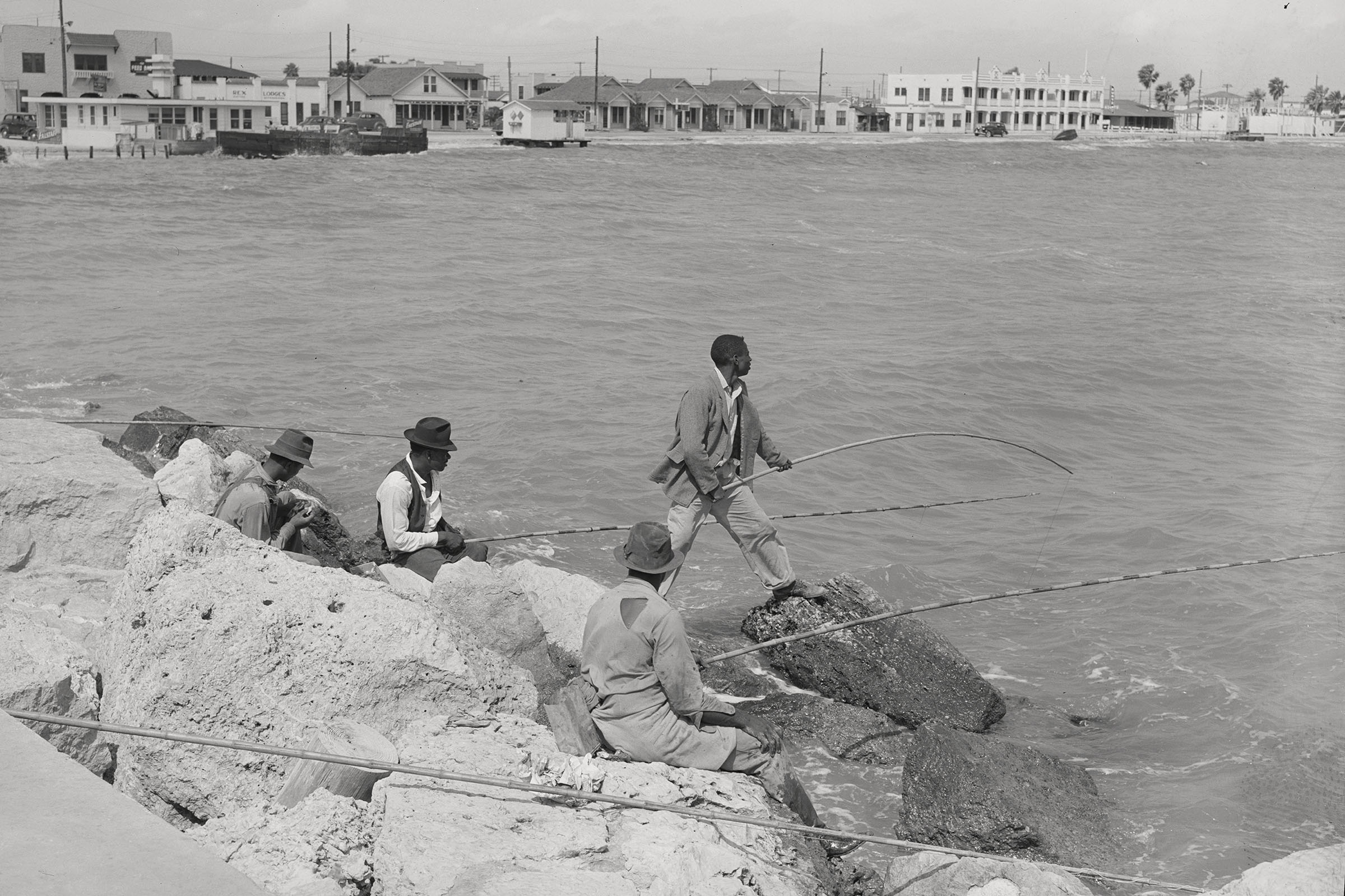Men fish off of a rock jetty in Corpus Christi Texas