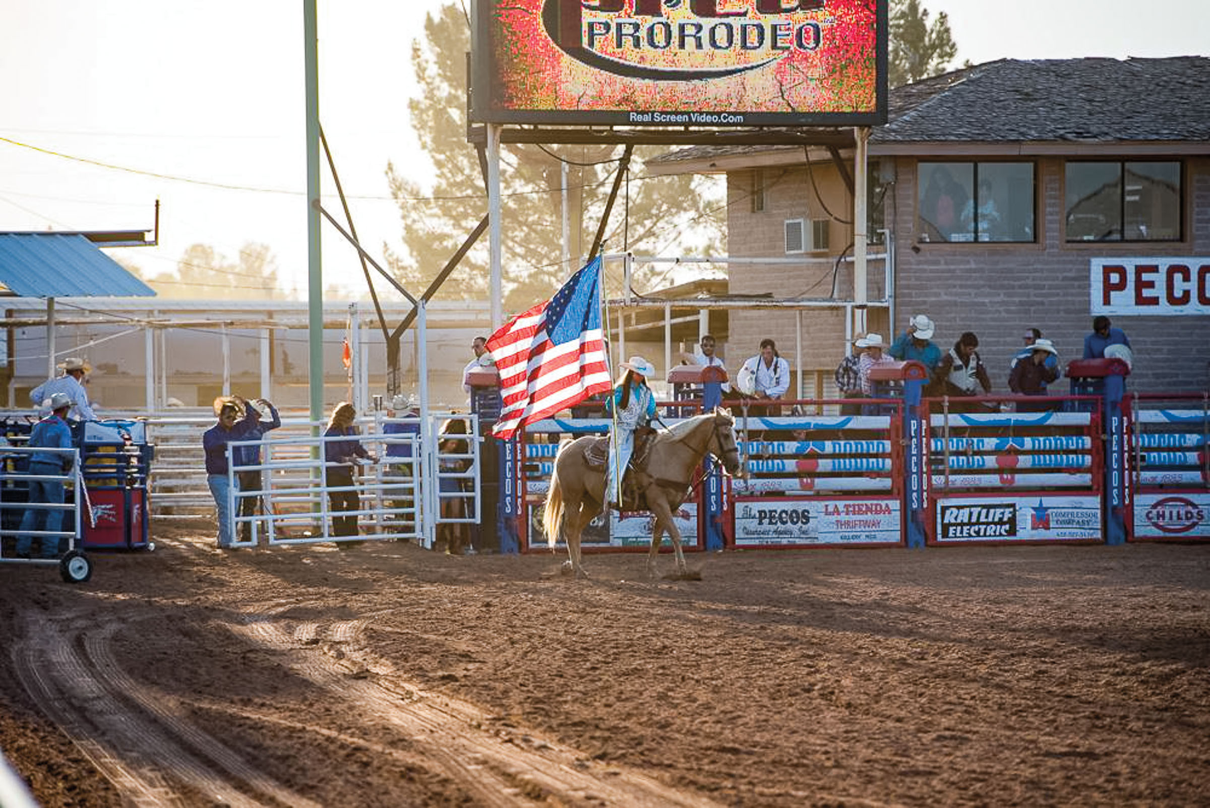 one of the west Texas Dandies parades the flag during the opening ceremony at the West of Pecos Rodeo.