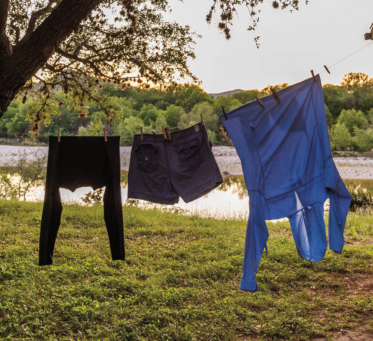 Clothes hang from a clothesline along the banks of the Nueces River