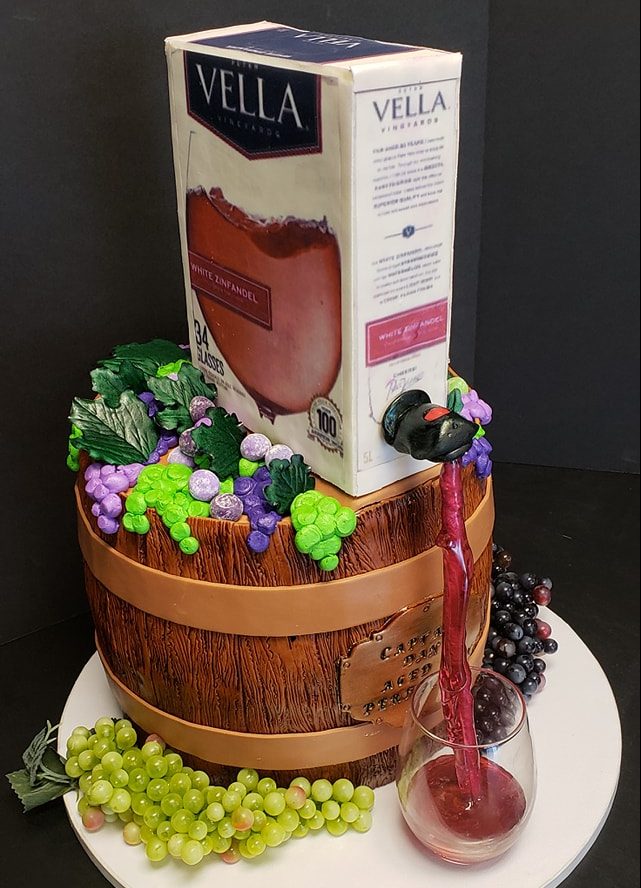 Boxed wine cake pouring wine into a glass