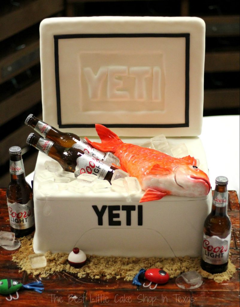 Yeti ice chest cake with beer bottles and a fish