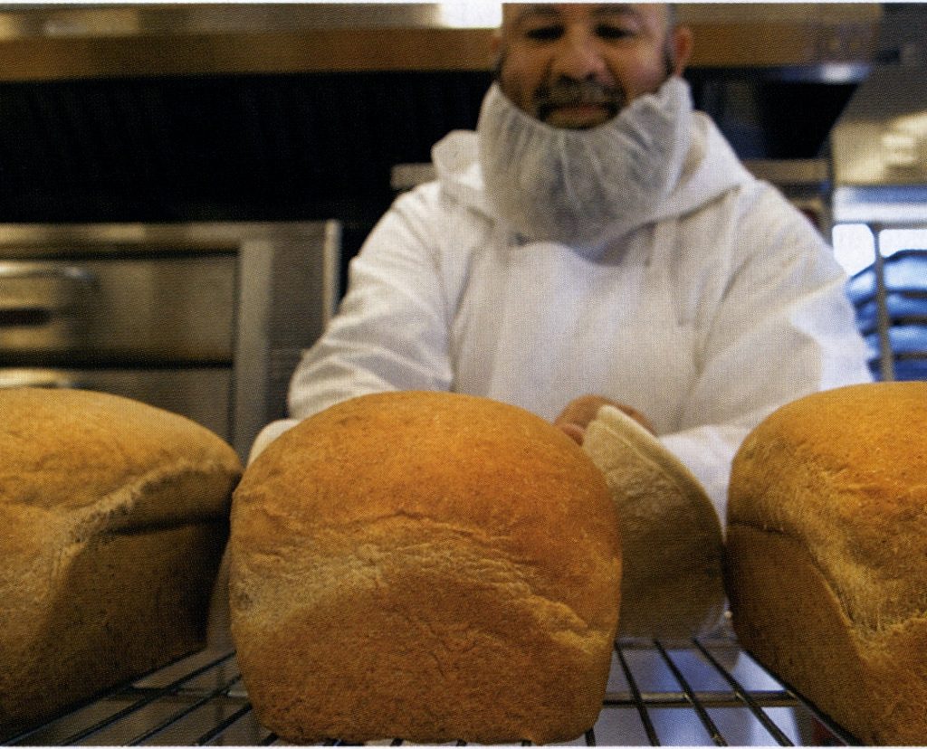 Brother John David, who does most of the baking in the commercial kitchen, turns out hundreds of loaves of bread a week during the holiday season. (Photo by Michael Amador)