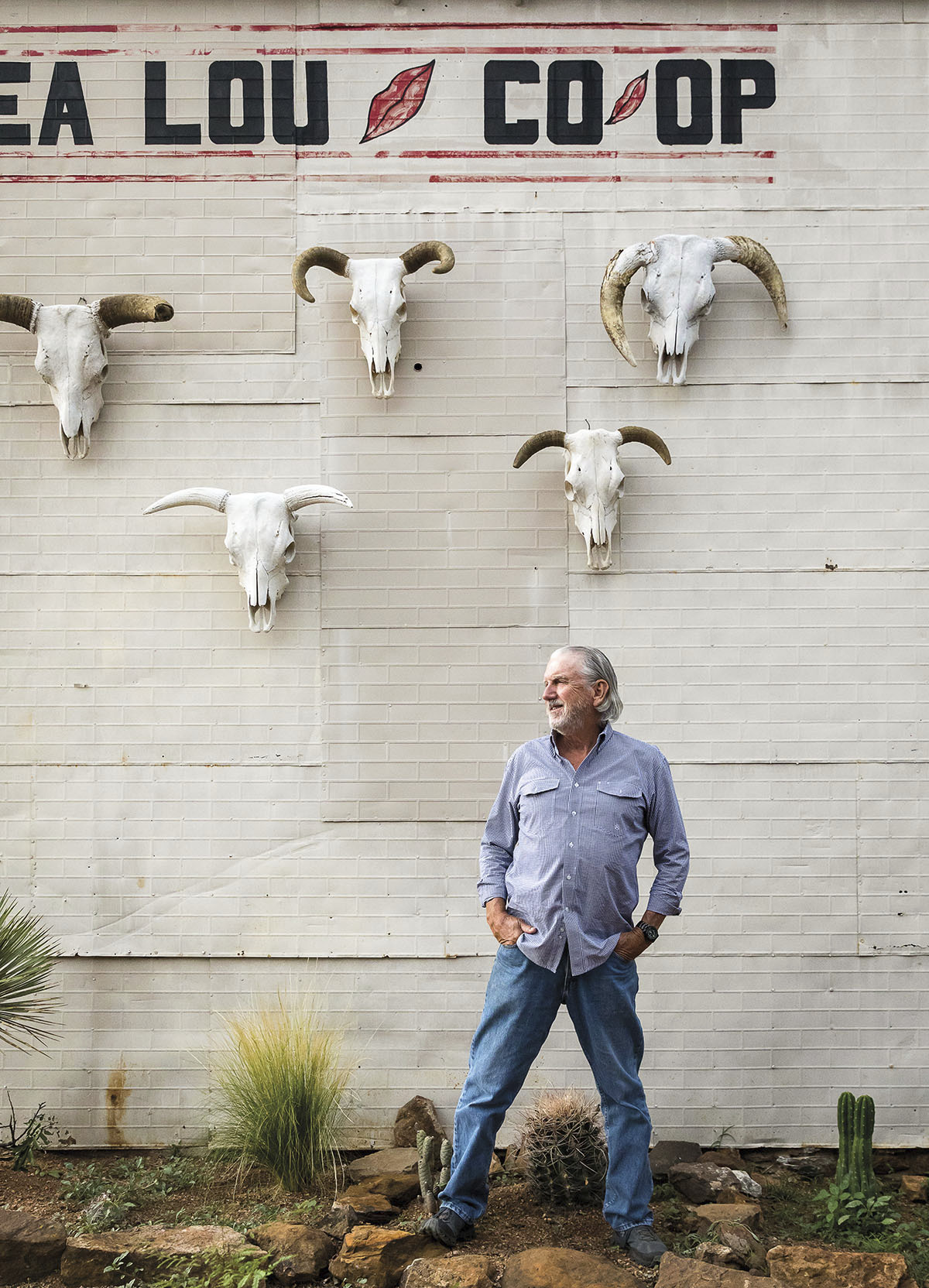Andy Smith at Lea Lou Co-Op and 21 Club. Cattle skulls hang on the wall behind him