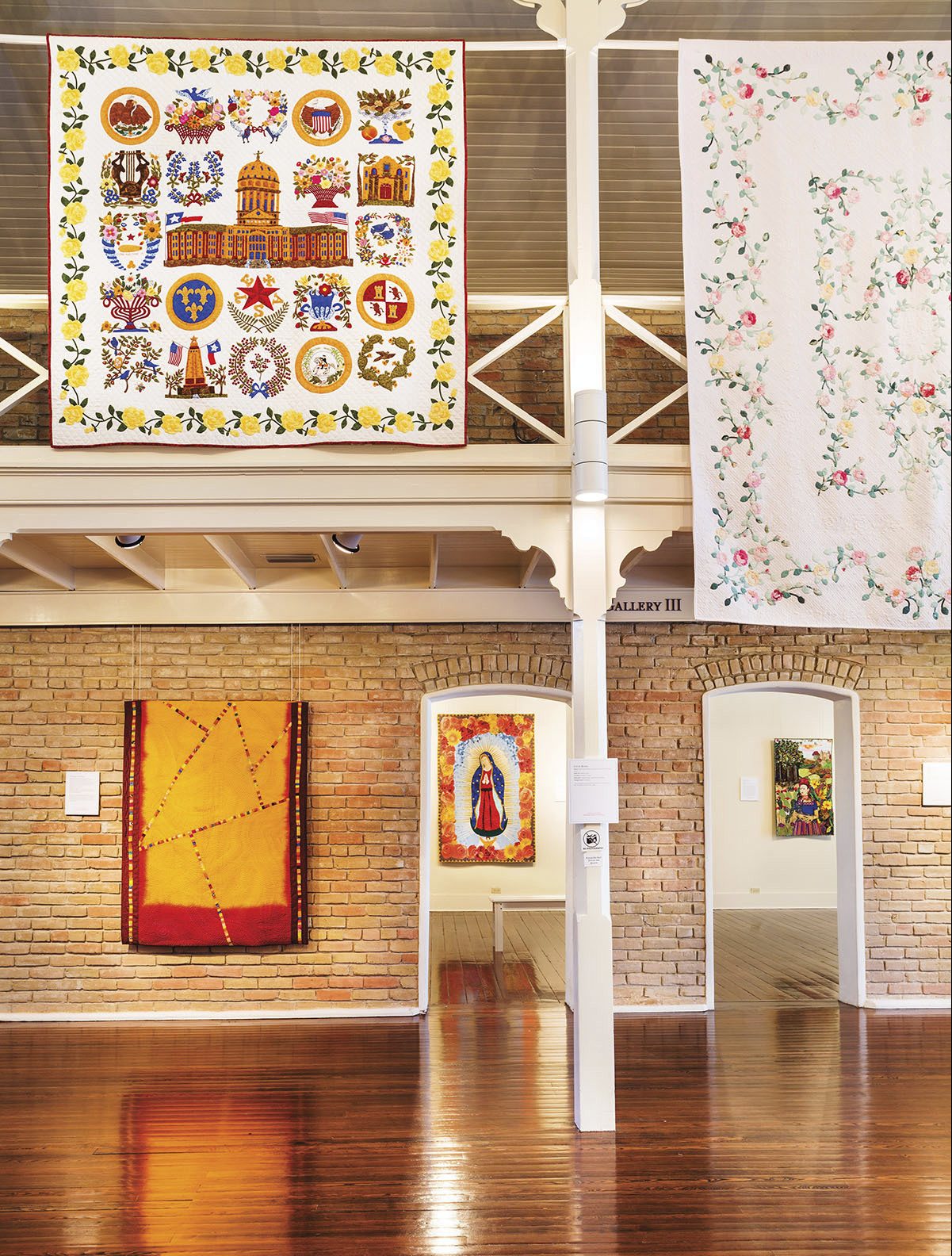 Quilts hang across the inside of the Texas Quilt Museum