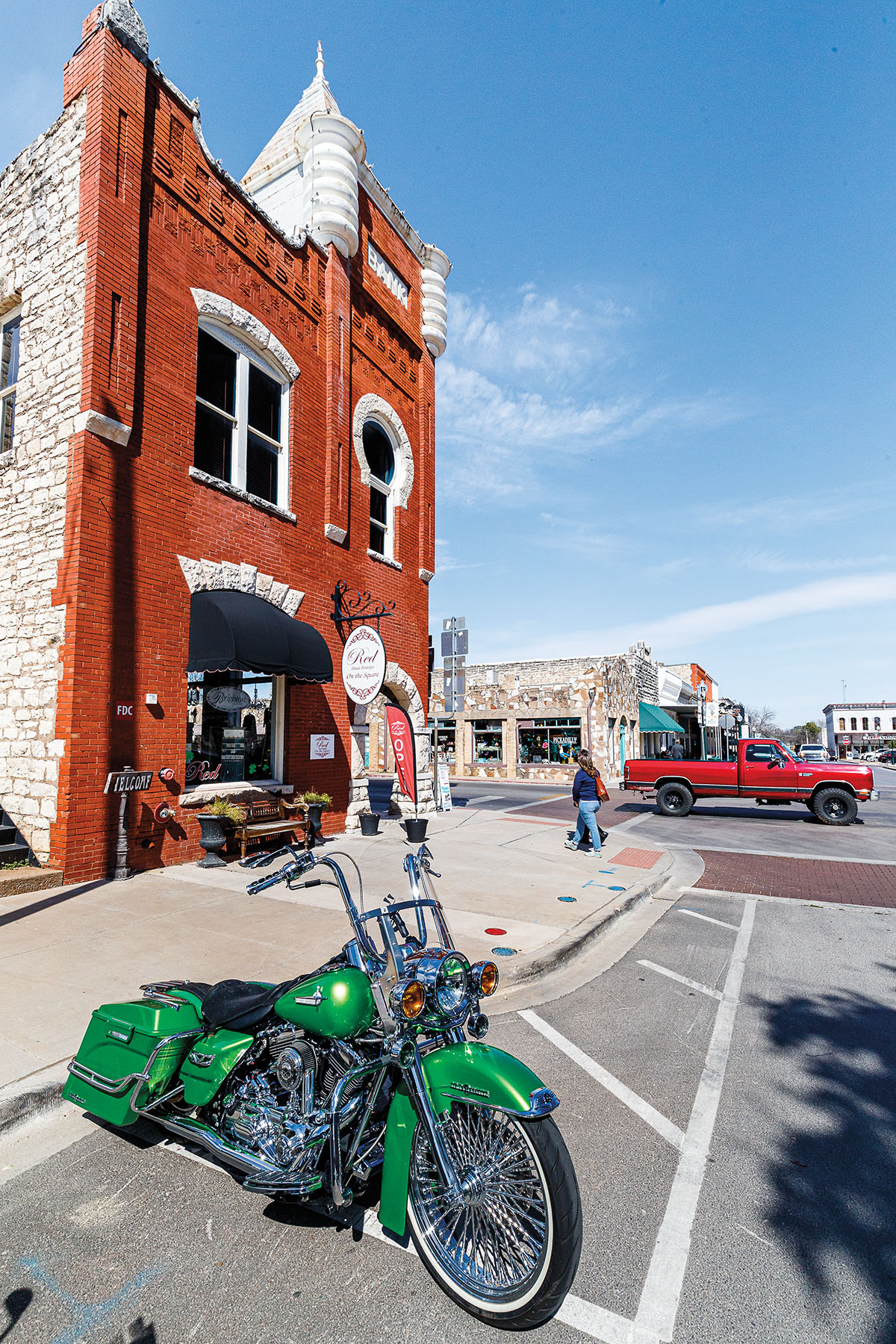 Green Harley Davidson motorcycle on street near downtown square, Granbury, Texas, USA.