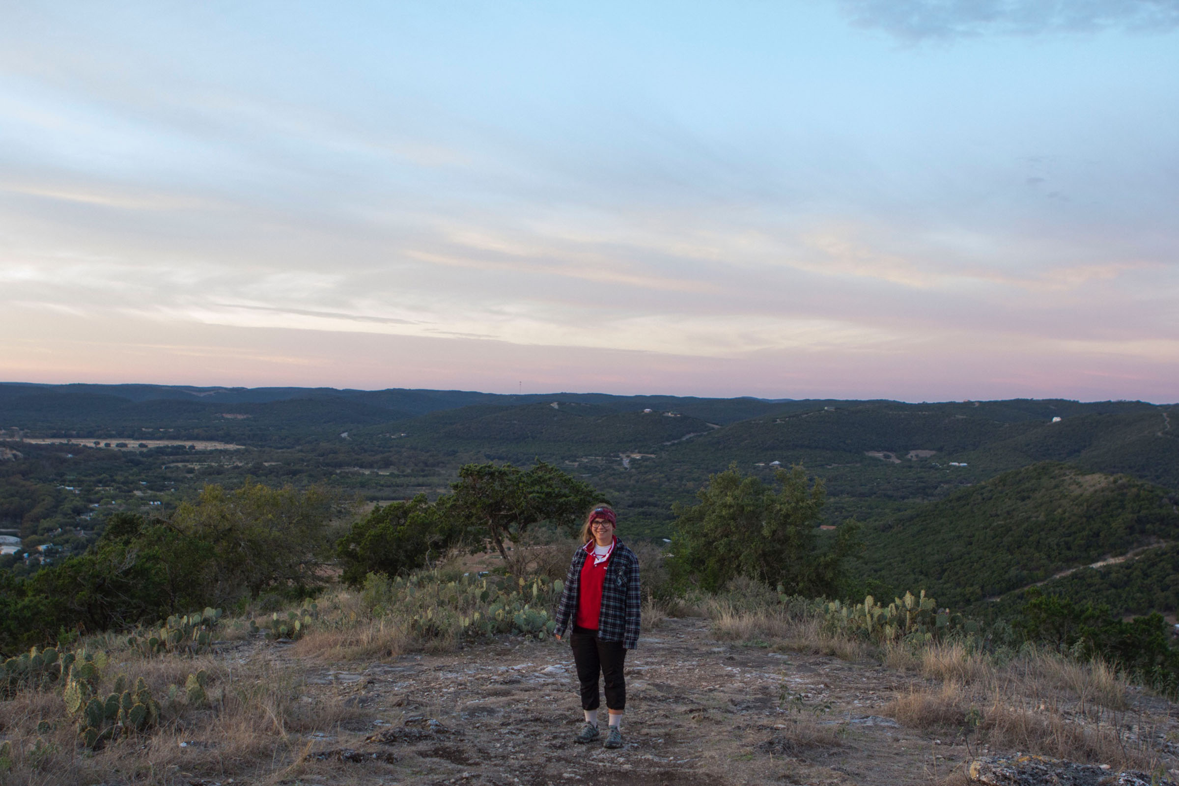 A woman stands at the top of the hill called Old Baldy in Garner State Park, Texas