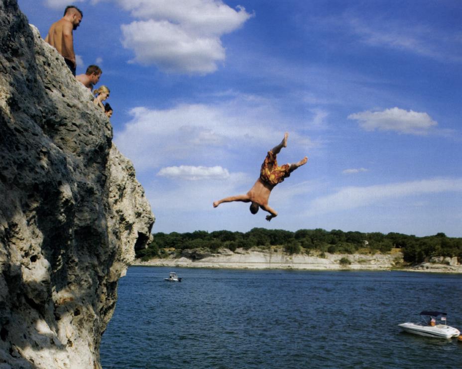 Waco's Preston Finley takes a flying leap into the cool blue water of Lake Whitney.