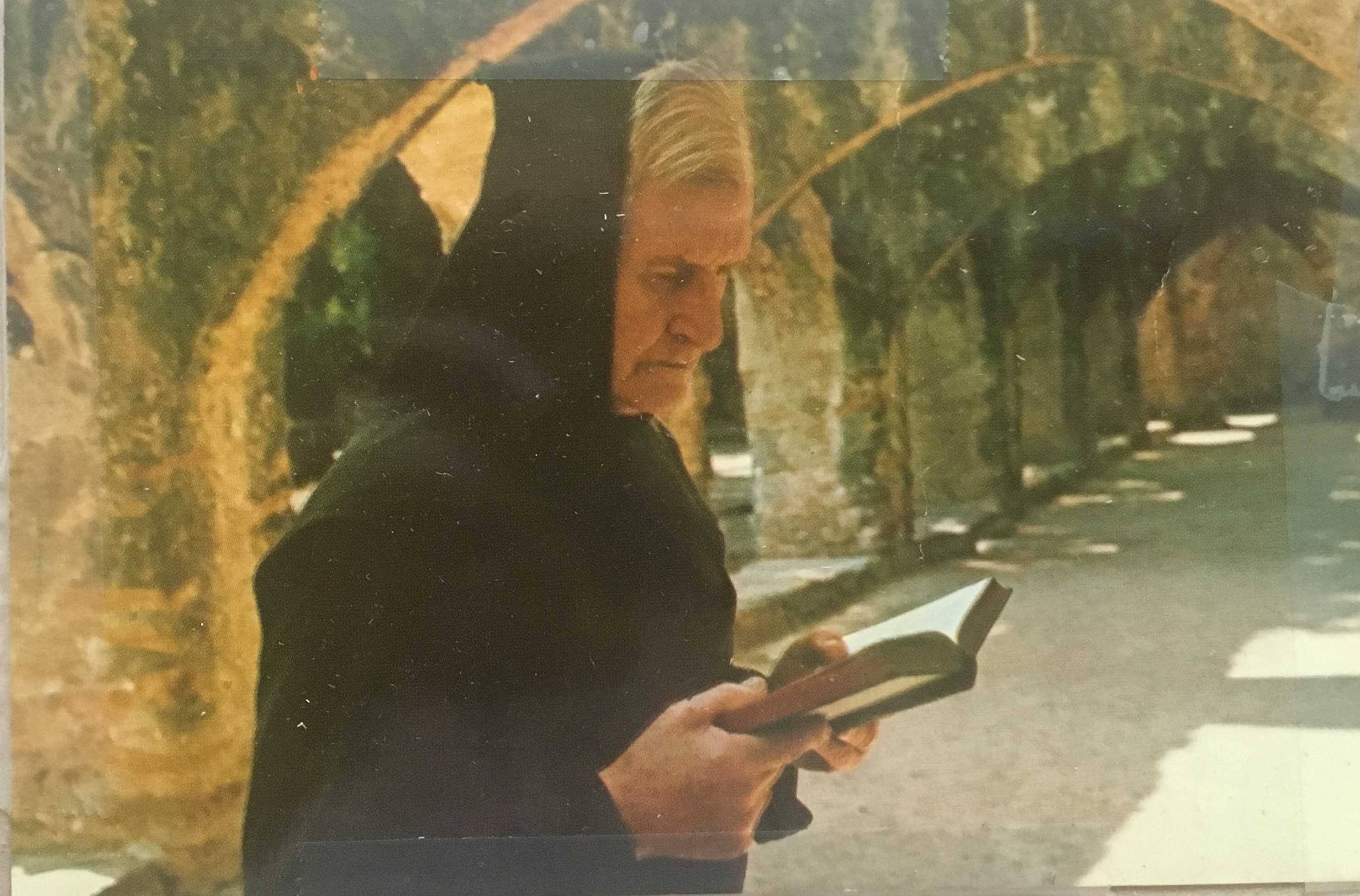 Brother Adrian reads from a book at Mission San José.