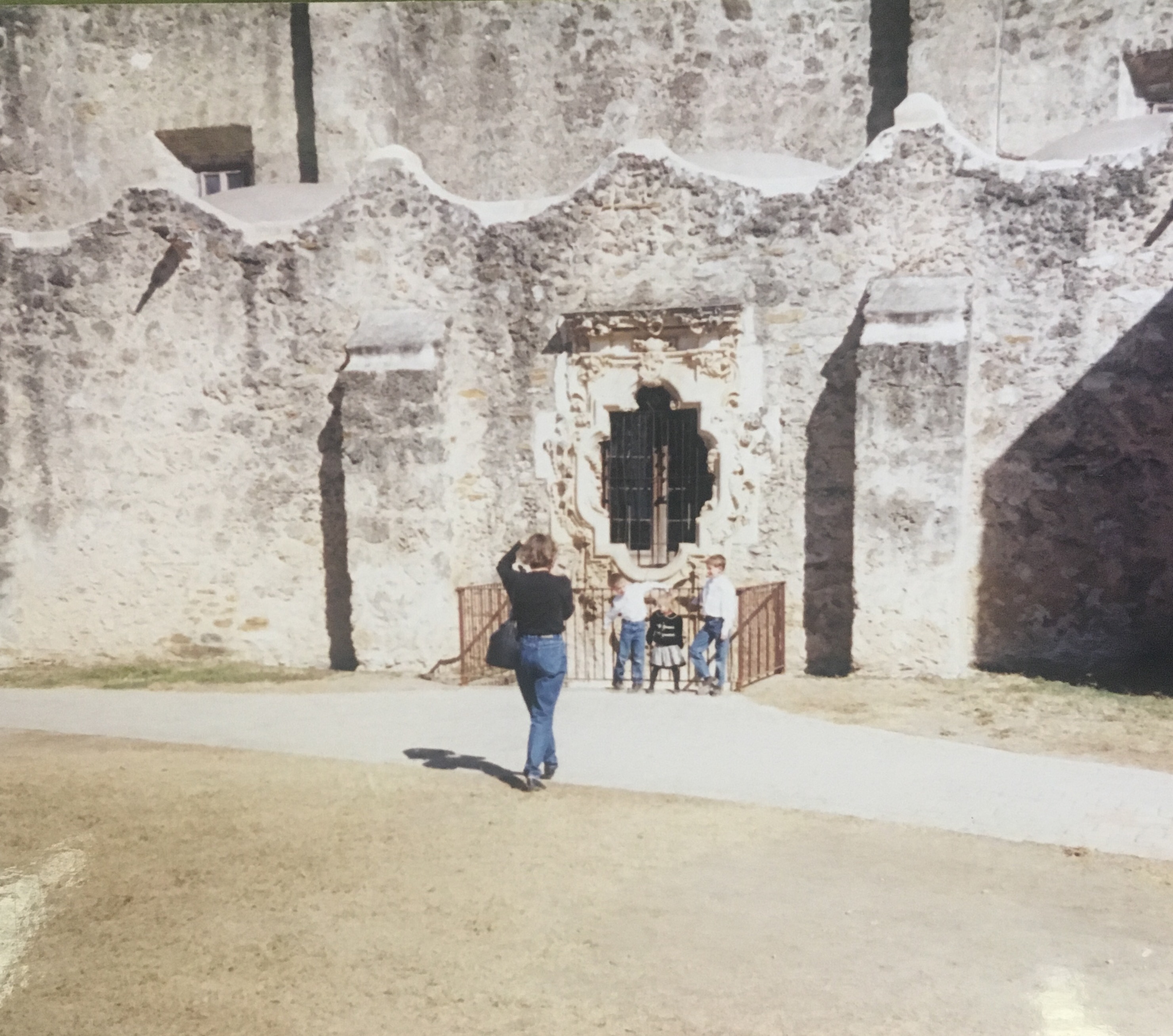 Annette Bernhard Nevins photographs her three children in front of Mission San José's famed Rose Window.